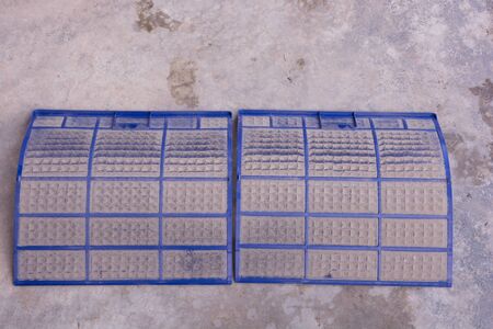 Very dirty air conditioner filter on cement floorの写真素材
