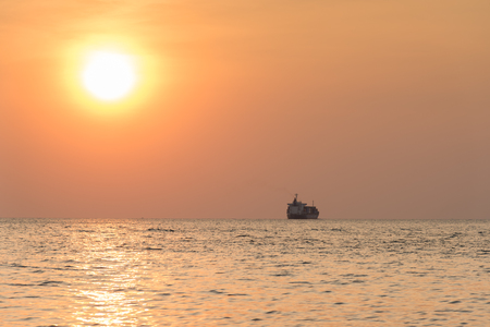 Cargo container ship at the sea in sunsetの写真素材