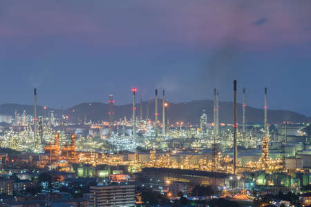 industrial power plant oil station night landscape with lights at sunsetの写真素材