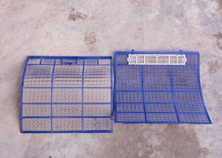 Very dirty air conditioner filter on cement floorの写真素材