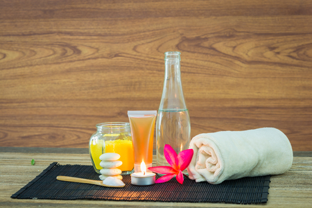 Spa still life with aromatic candles, Frangipani flowers and towel on wooden backgroundの写真素材