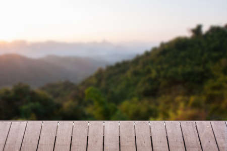 Wood table top on Majestic sunset in the mountains landscape background can put or montage your productsの写真素材