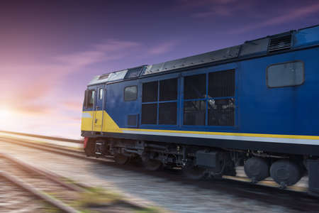 Fast freight blue train at sunset with motion blurの写真素材