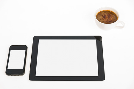 Digital tablet touch pad computer with coffee in office table businessの写真素材