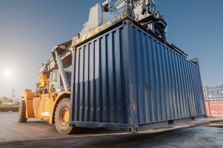 forklift handling container box loading from dock to truckの写真素材