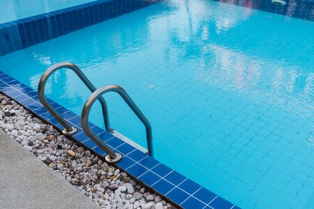 Hotel blue swimming pool with stair for relaxation