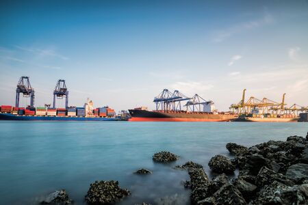 Containers cargo loading box by crane Trade Port Shippingの写真素材