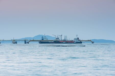 Oil Tanker loading oil in the sea with sunsetの写真素材