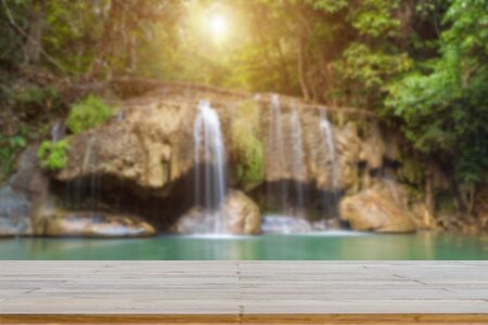 Wooden plank and background with Blur Waterfall Erawan Parkの写真素材