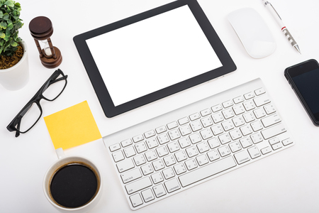 Digital tablet touch pad computer with keyboard, mouse and coffee in Office workplace table businessの写真素材