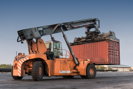 Forklift handling container box loading at the Docks with Truckの写真素材