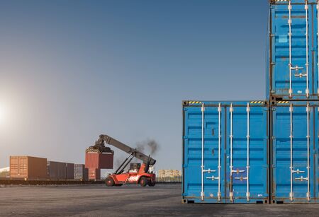 forklift handling container box loading from dock to truckの写真素材