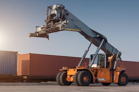 forklift handling container box loading from dock to truckの写真素材