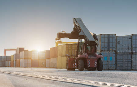 Forklift handling no container box loading at sunsetの写真素材