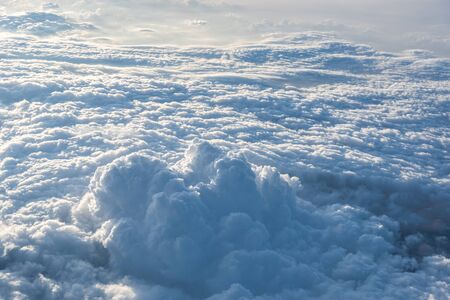 Many cloud in Flying above sunrise, view from outside airplane