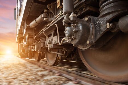 High speed diesel train on tracks with motion blur at sunset