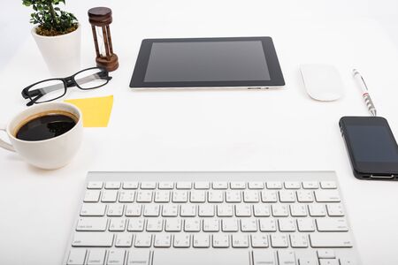 Digital tablet touch pad computer with keyboard, mouse and coffee in Office workplace table businessの写真素材