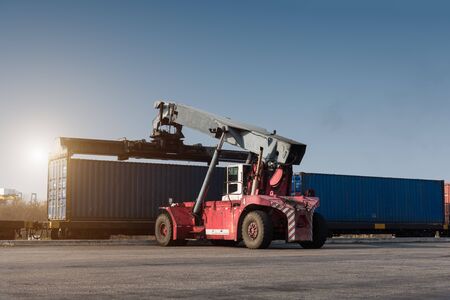 forklift handling container box loading from dock to truckの写真素材