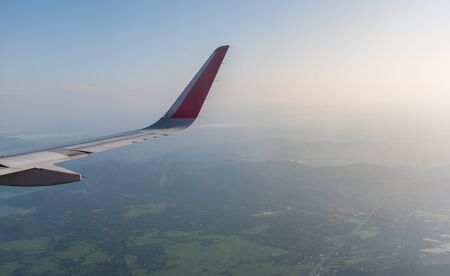 Aircraft wing transportation plane flying over clouds
