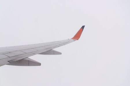 Aircraft wing flying on cloudscape, over cloudsの写真素材