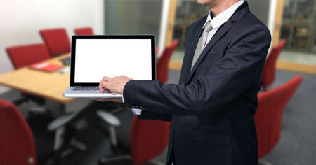 Businessman hold laptop computer in meeting roomの写真素材