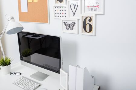 Modern home office computer monitor workspace on white desk