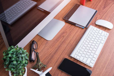 Workspace computer monitor with blank screen on desk office roomの写真素材