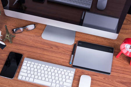 Workspace computer monitor with blank screen on desk office roomの写真素材
