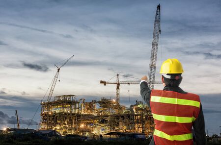 Worker man watching some details on construction