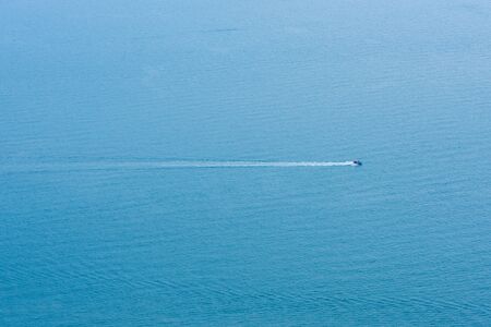 Speed Boat surf long foam aerial in blue seaの写真素材