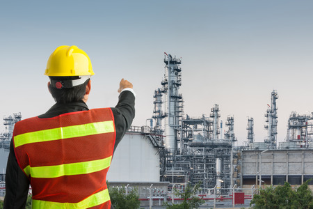 Petrochemical engineering man with white safety helmet standing in oil refinery building structure petrochemical industryの写真素材