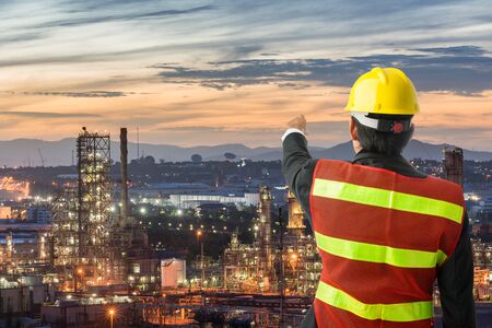 Petrochemical engineering man with white safety helmet standing in oil refinery building structure petrochemical industryの写真素材
