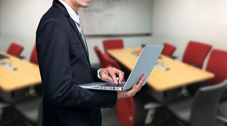 Businessman hold laptop computer in meeting roomの写真素材