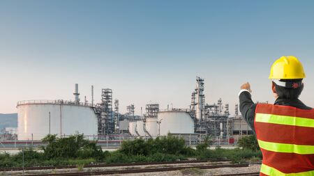 Petrochemical engineering man with white safety helmet standing in oil refinery building structure petrochemical industryの写真素材