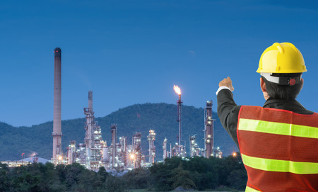 Petrochemical engineering man with white safety helmet standing in oil refinery building structure petrochemical industryの写真素材