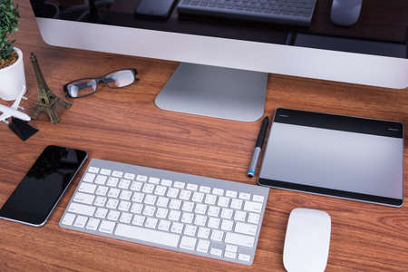 Workspace computer monitor with blank screen on desk office roomの写真素材