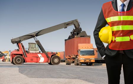 Businessman stand on front forklift loading Containers box to Logistic cargo Import Exportの写真素材
