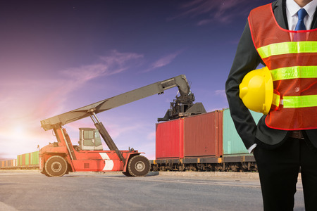 Foreman or working businessman stand on front forklift loading Containers box to Logistic cargo Import Export Backgroundの写真素材