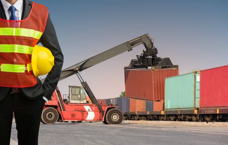 Foreman or working businessman stand on front forklift loading Containers box to Logistic cargo Import Export Backgroundの写真素材