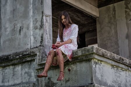 Zombie, Ghost, Woman murder with bloody sit wait for help on abandoned building ,halloween conceptの写真素材