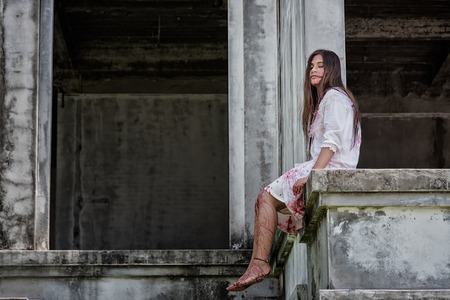 Zombie, Ghost, Woman murder with bloody sit wait for help on abandoned building ,halloween conceptの写真素材