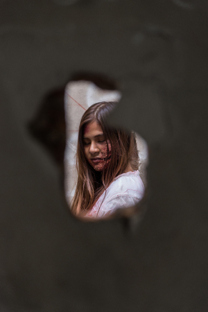 Zombie or Ghost woman with bloody in hole cement broken ,halloween concept