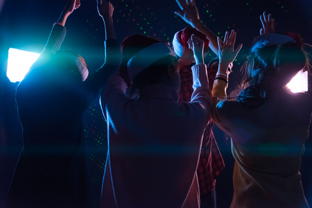 Group Asian young friends dancing Together party with Disco lights celebrating Christmas at dark home, Christmas or New Year conceptの写真素材