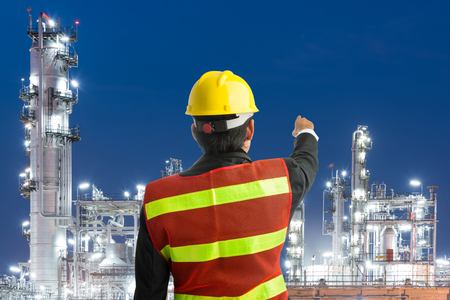 Petrochemical engineering man with white safety helmet standing in oil refinery building structure petrochemical industryの写真素材