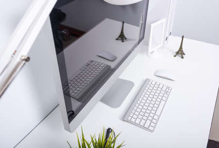 Top view computer monitor on home office white deskの写真素材