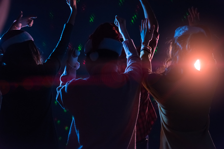 Group Asian young friends dancing Together party with Disco lights celebrating Christmas at dark home, Christmas or New Year conceptの写真素材