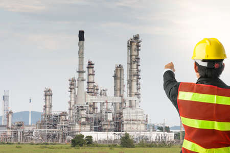 Petrochemical engineering man with white safety helmet standing in oil refinery building structure petrochemical industryの写真素材