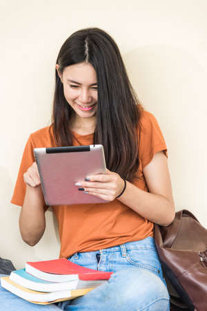 Young woman girls sitting useing with technology at universityの写真素材