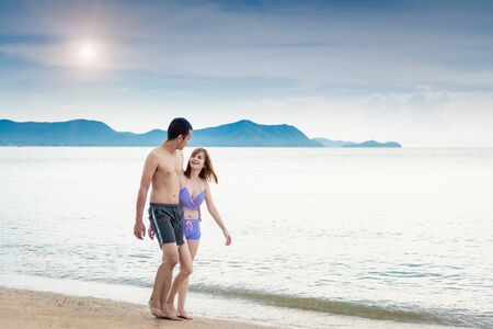 Young Couple walking romantic travel honeymoon on Beach in summer holidays.の写真素材