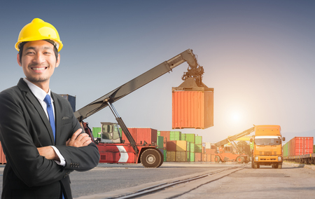 Businessman stand on front forklift loading Containers box to Logistic cargo Import Export Backgroundの写真素材